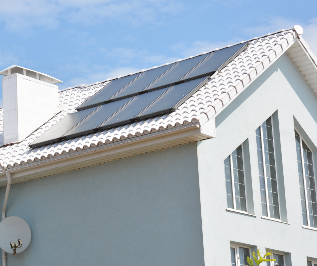 A home is seen with solar panels installed on the roof. Solar panel installation is an advanced strategy for energy-efficient remodeling.  