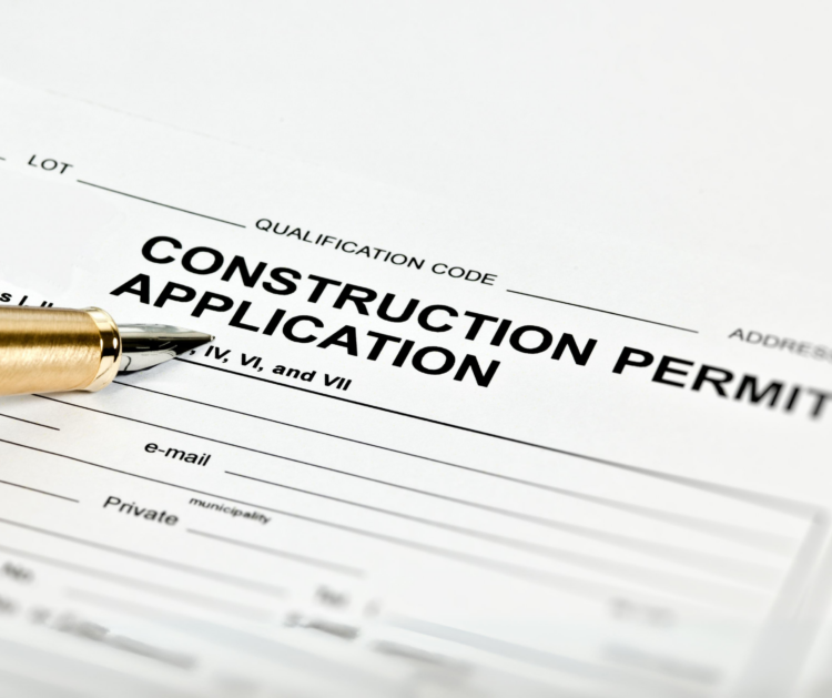 A close-up of a pen on a construction remodeling permits application