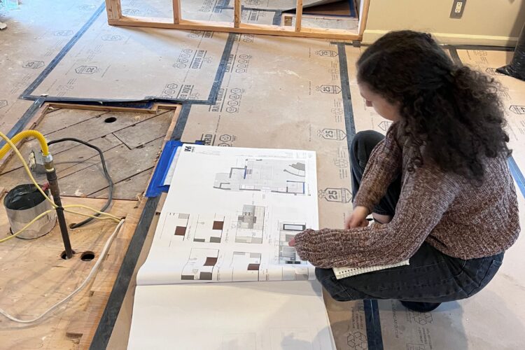 Designer at a cabinetry review meeting on-site with Superintendent and Project Manager