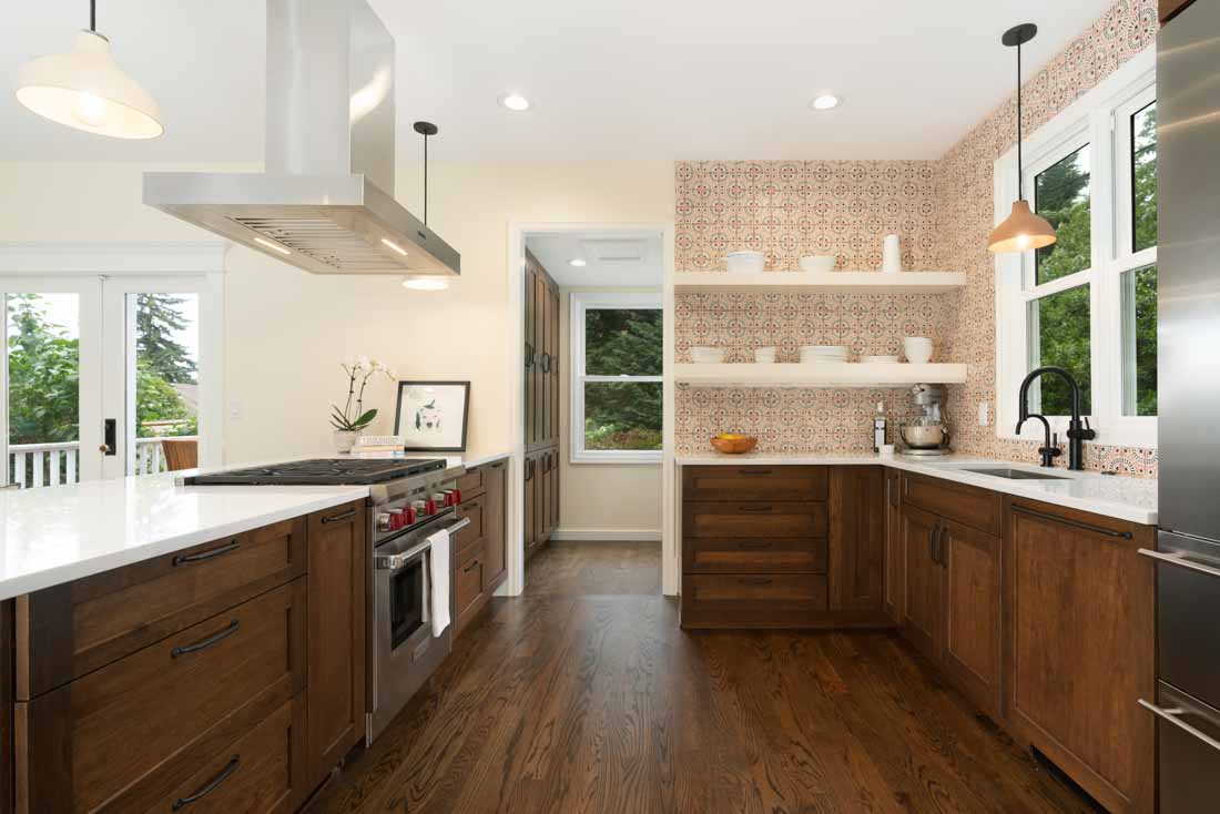 Remodeling a historic home presents numerous opportunities to combine modern necessities with historic character. Seen here in this photo of a historic kitchen remodel, the design team chose molding and tile that honor the home's original architectural period. 